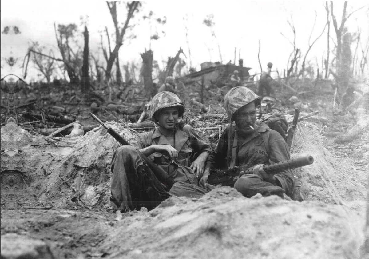  A U.S. Marine (R) cradles his M1919 Browning machine gun at Peleliu during World War II. (Public domain)