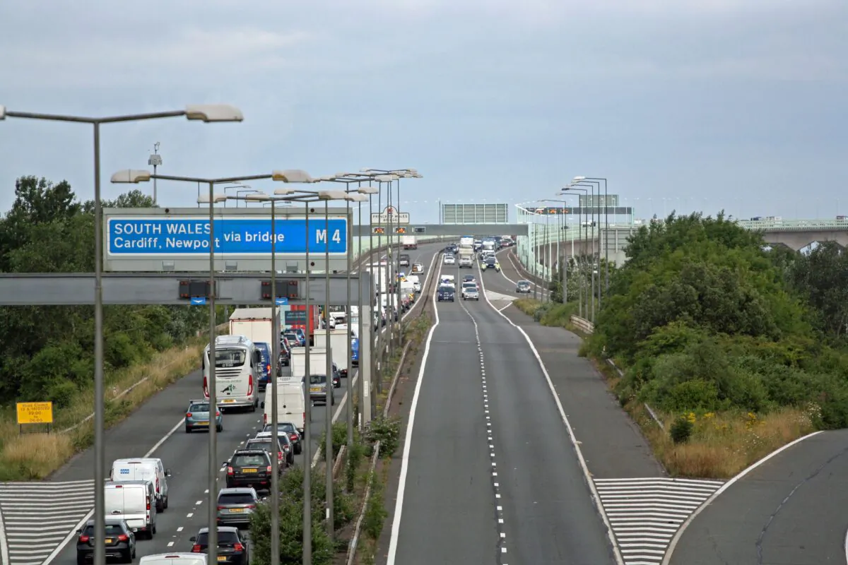 Police escort vehicles across the Prince of Wales Bridge, which runs between England and Wales, during the morning rush hour as drivers hold a go-slow protest on the M4 on July 4, 2022. (Rod Minchin/PA Media)