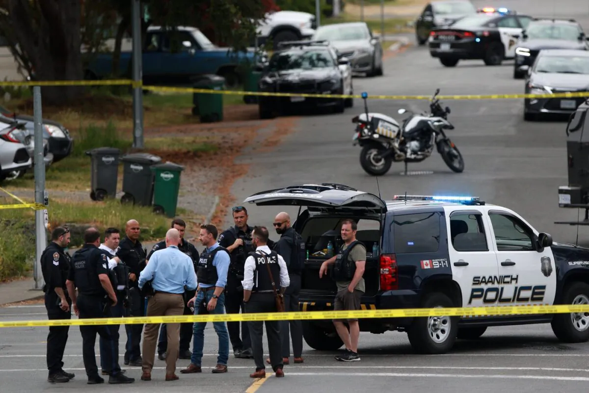 Saanich Police joined by Victoria Police and RCMP respond to gunfire involving multiple people and injuries reported at the Bank of Montreal during an active situation in Saanich, B.C., on June 28, 2022. (The Canadian Press/Chad Hipolito)