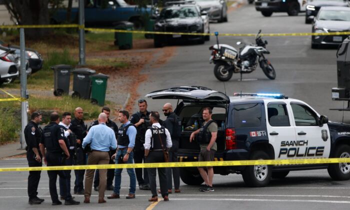 Saanich Police joined by Victoria Police and RCMP respond to gunfire involving multiple people and injuries reported at the Bank of Montreal during an active situation in Saanich, B.C., on June 28, 2022. (The Canadian Press/Chad Hipolito)