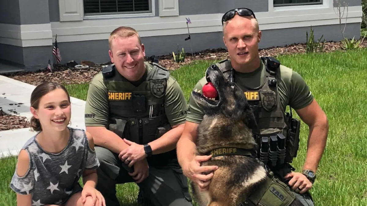 (L–R) Emma Stanford, Chief Jonathan Welker, and Sgt. Robert Tarczewski and his partner K9 Tag in Palm Coast, Fla., in June 2018. (Courtesy of Carmen Stanford via The Center Square)