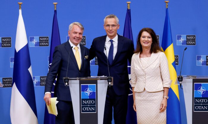 Sweden's Foreign Minister Ann Linde (R), and Finland's Foreign Minister Pekka Haavisto (L) attend a news conference with NATO Secretary General Jens Stoltenberg, after signing their countries' accession protocols at the alliance's headquarters in Brussels on July 5, 2022. (Yves Herman/Reuters)