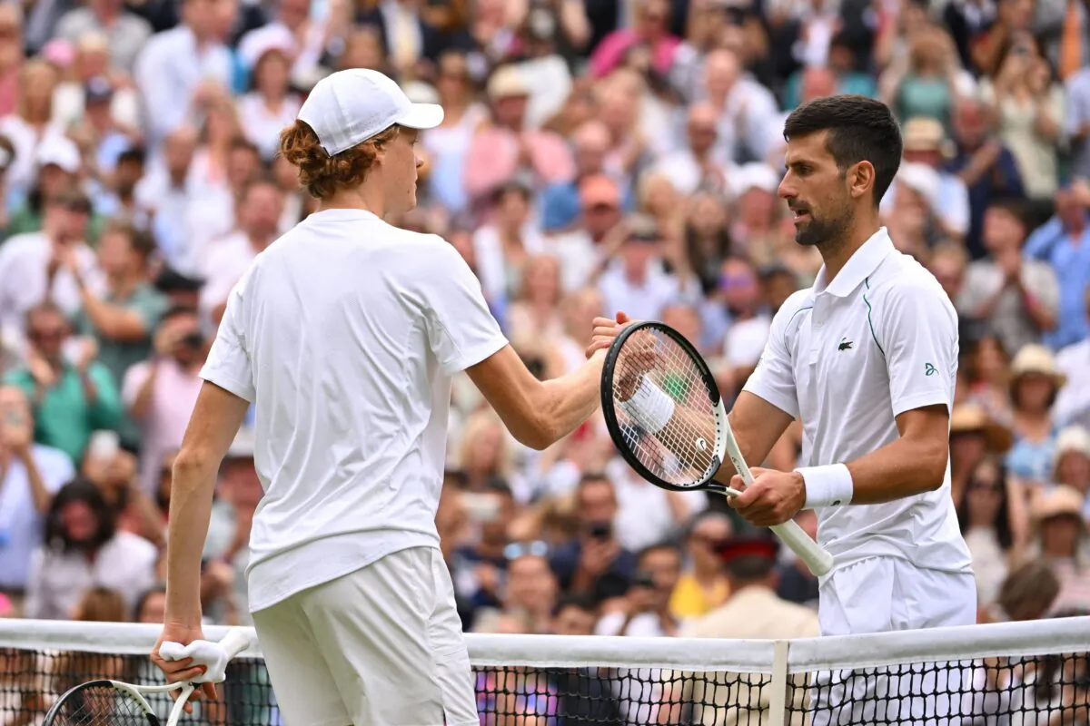 Serbia's Novak Djokovic (R) and Italy's Jannik Sinner shake hands after their men's singles quarter final tennis match on the ninth day of the 2022 Wimbledon Championships at The All England Tennis Club in Wimbledon, southwest London, on July 5, 2022. (Sebastien Bozon/AFP via Getty Images)