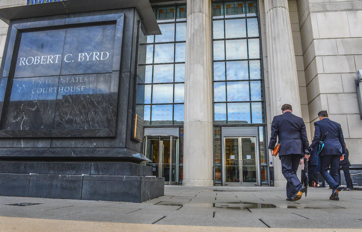 Huntington Mayor Steve Williams, left, and lawyer Rusty Webb enter the Robert C. Byrd United States Courthouse in Charleston, W.Va., on May 3, 2021. (Kenny Kemp/Charleston Gazette-Mail via AP)