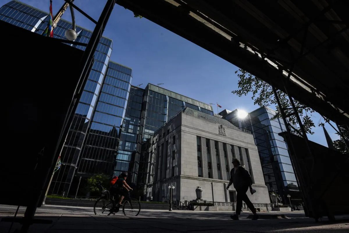 People pass the Bank of Canada building on Wellington Street in Ottawa, on May 31, 2022. (The Canadian Press/Justin Tang)