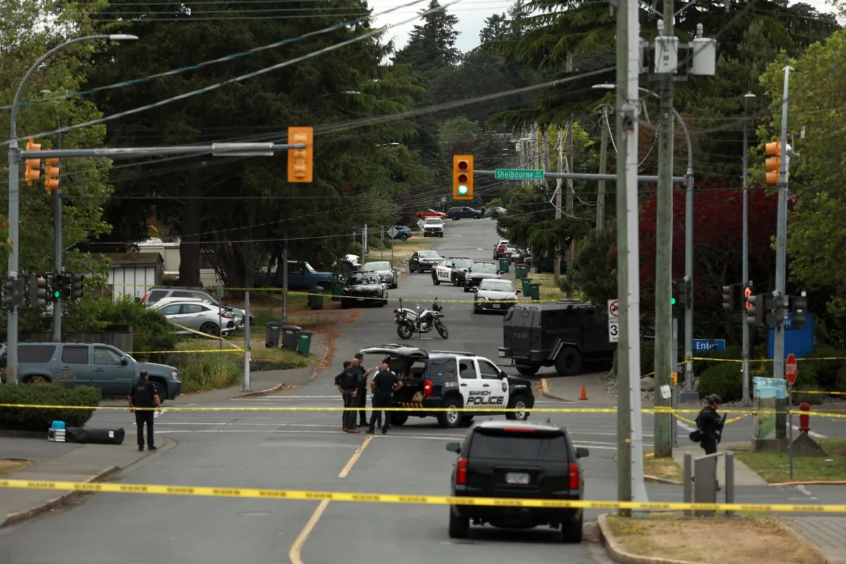 Saanich Police joined by Victoria Police and RCMP respond after a shootout outside a Bank of Montreal where two suspects were killed and six officers were injured in Saanich, B.C., on June 28, 2022. (The Canadian Press/Chad Hipolito)