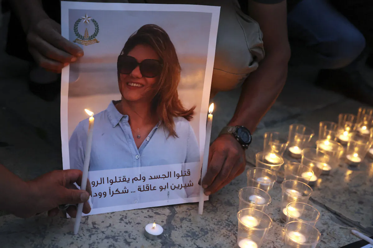 Family and friends of al-Jazeera reporter Shireen Abu Akleh, Anton Abu Akleh, attend a candle vigil outside the Church of the Nativity in the West Bank Biblical city of Bethlehem on May 16, 2022. (Hazem Bader/AFP via Getty Images)