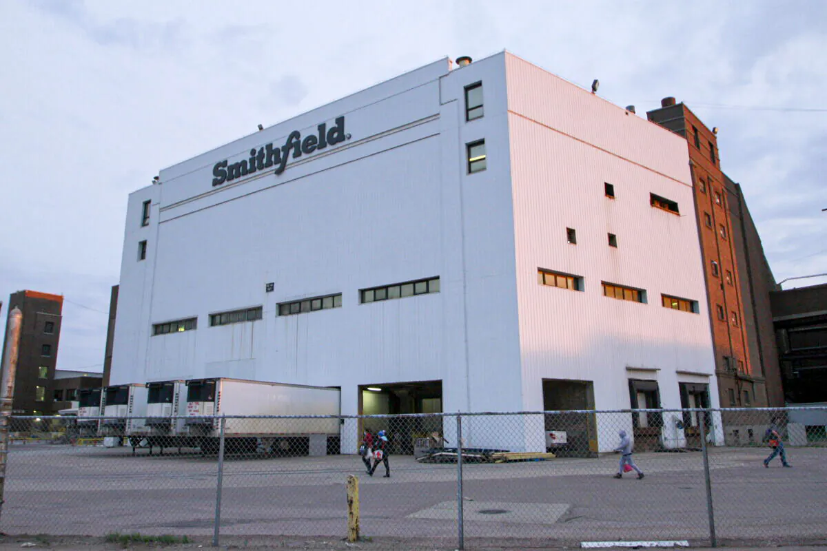 Employees of two departments report to work at the Smithfield pork processing plant in Sioux Falls, S.D., on May 4, 2020. (Stephen Groves/AP Photo)