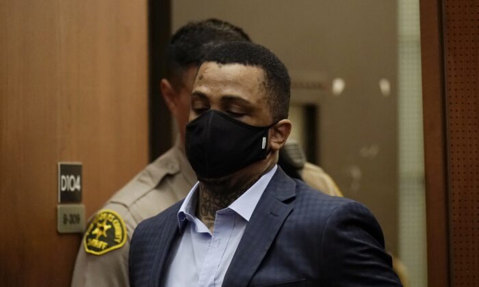 Eric Holder Jr., who is accused of killing rapper Nipsey Hussle, enters a courtroom to hear the verdicts in his murder trial at Los Angeles Superior Court in Los Angeles on July 6, 2022. (Jae C. Hong/Pool via AP)