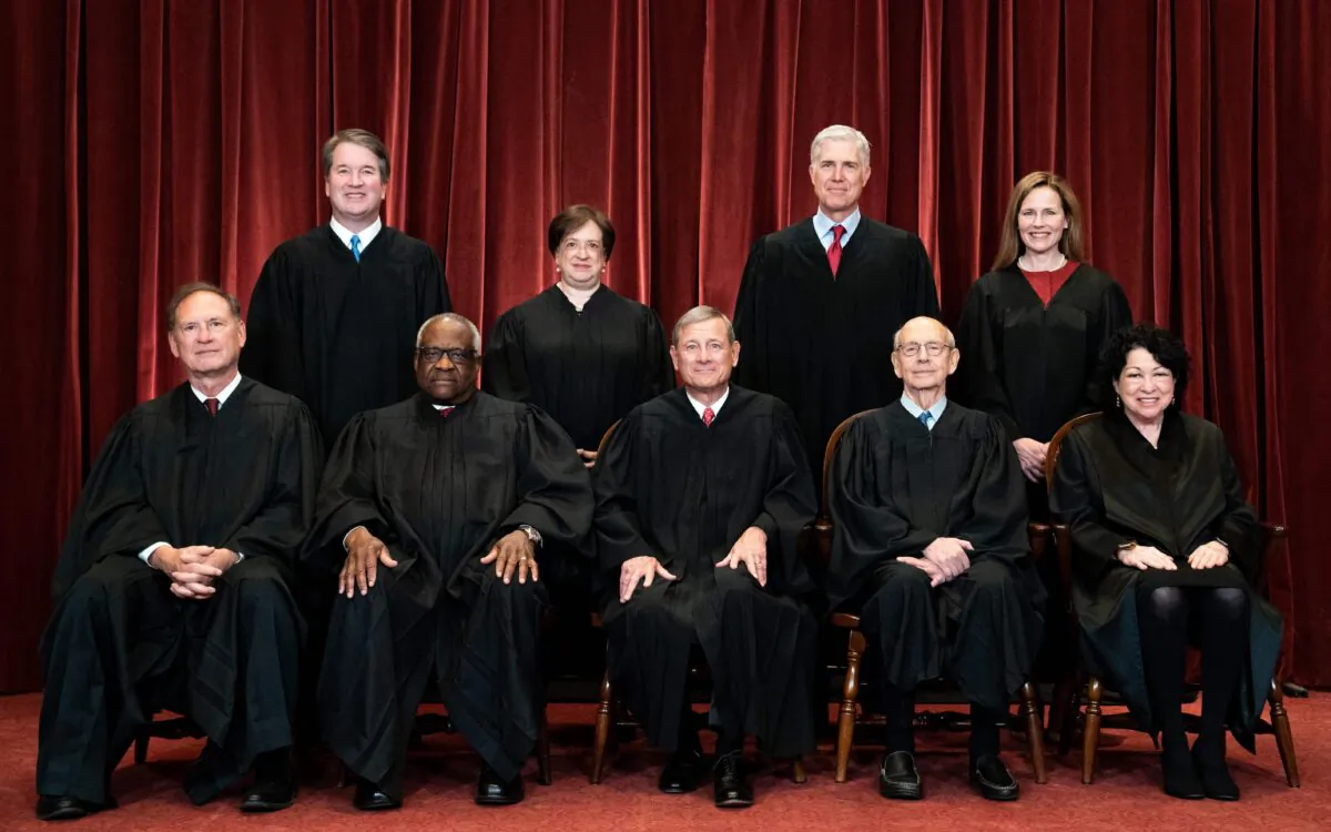 Members of the Supreme Court pose for a group photo at the Supreme Court in Washington, D.C., on April 23, 2021. Seated from left: Justices Samuel Alito and Clarence Thomas, Chief Justice John Roberts, and Justices Stephen Breyer and Sonia Sotomayor. Standing from left: Justices Brett Kavanaugh, Elena Kagan, Neil Gorsuch, and Amy Coney Barrett. (Erin Schaff/Pool/Getty Images)