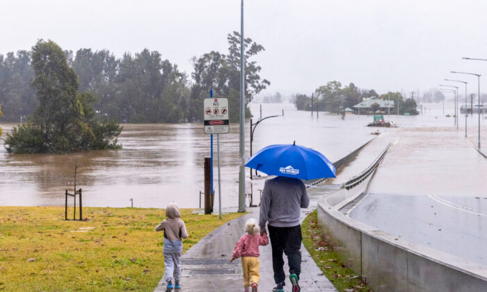 People view the flooded Windsor Bridge along the Hawkesbury River in the suburb of Windsor in Sydney, Australia, on July 4, 2022. (Jenny Evans/Getty Images)