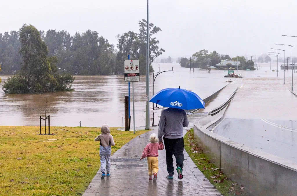 People view the flooded Windsor Bridge along the Hawkesbury River in the suburb of Windsor in Sydney, Australia, on July 4, 2022. (Jenny Evans/Getty Images)