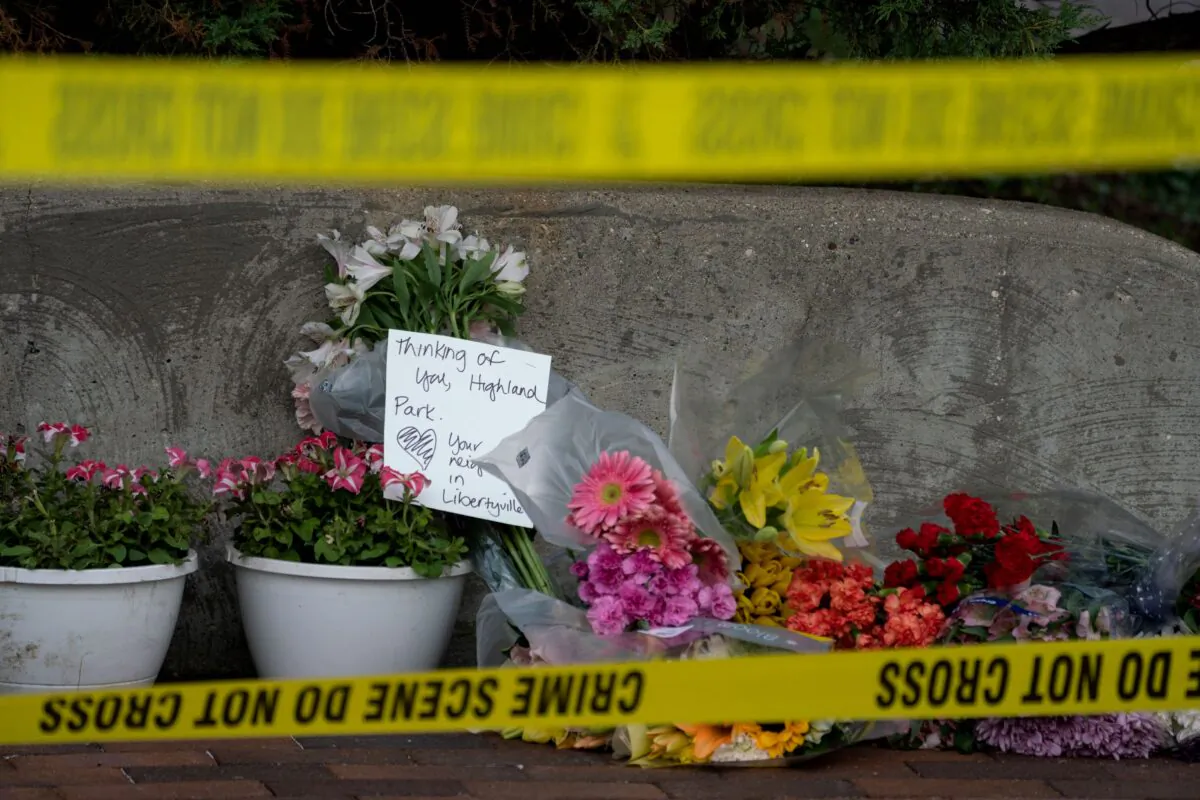 Flowers are left for victims of the 4th of July mass shooting in downtown Highland Park, Ill., on July 5, 2022. (Max Herman/AFP via Getty Images)