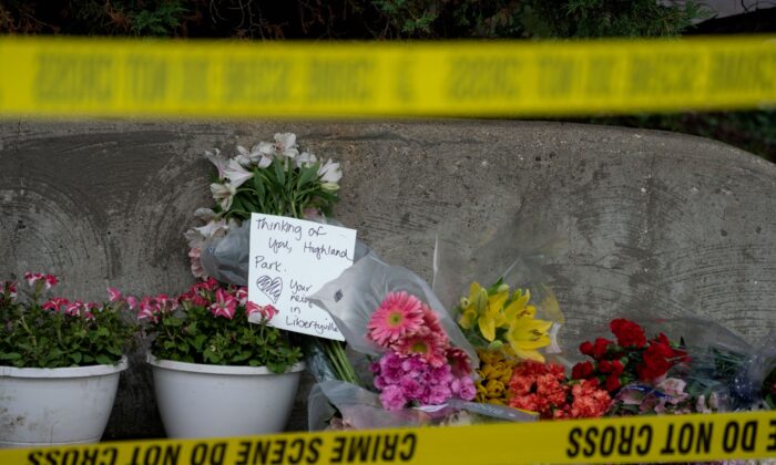 Flowers are left for victims of the 4th of July mass shooting in downtown Highland Park, Ill., on July 5, 2022. (Max Herman/AFP via Getty Images)