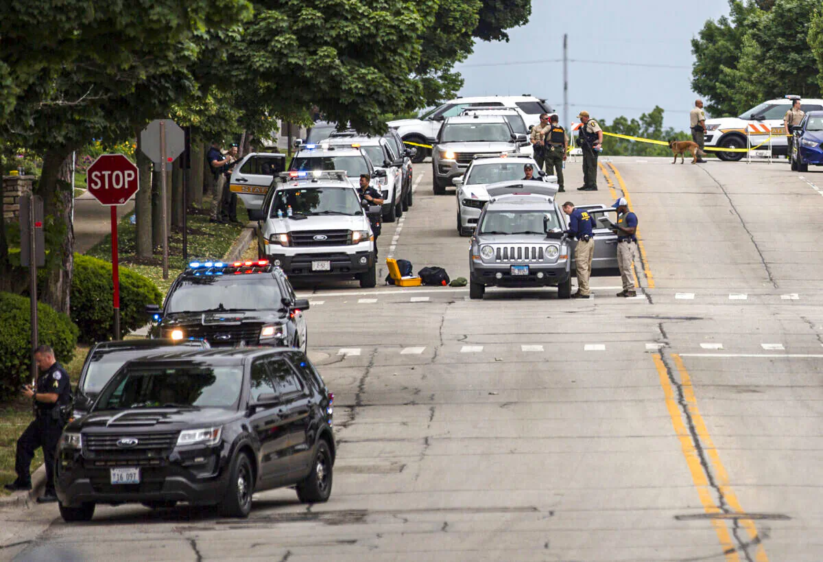 Law enforcement works the scene after a mass shooting at a Fourth of July parade in Highland Park, Ill., on July 4, 2022. (Jim Vondruska/Getty Images)