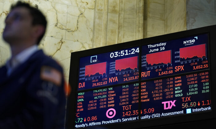 A screen at the New York Stock Exchange shows a lot of red, indicating widespread stock market losses, on June 16, 2022. (AP Photo/Seth Wenig)