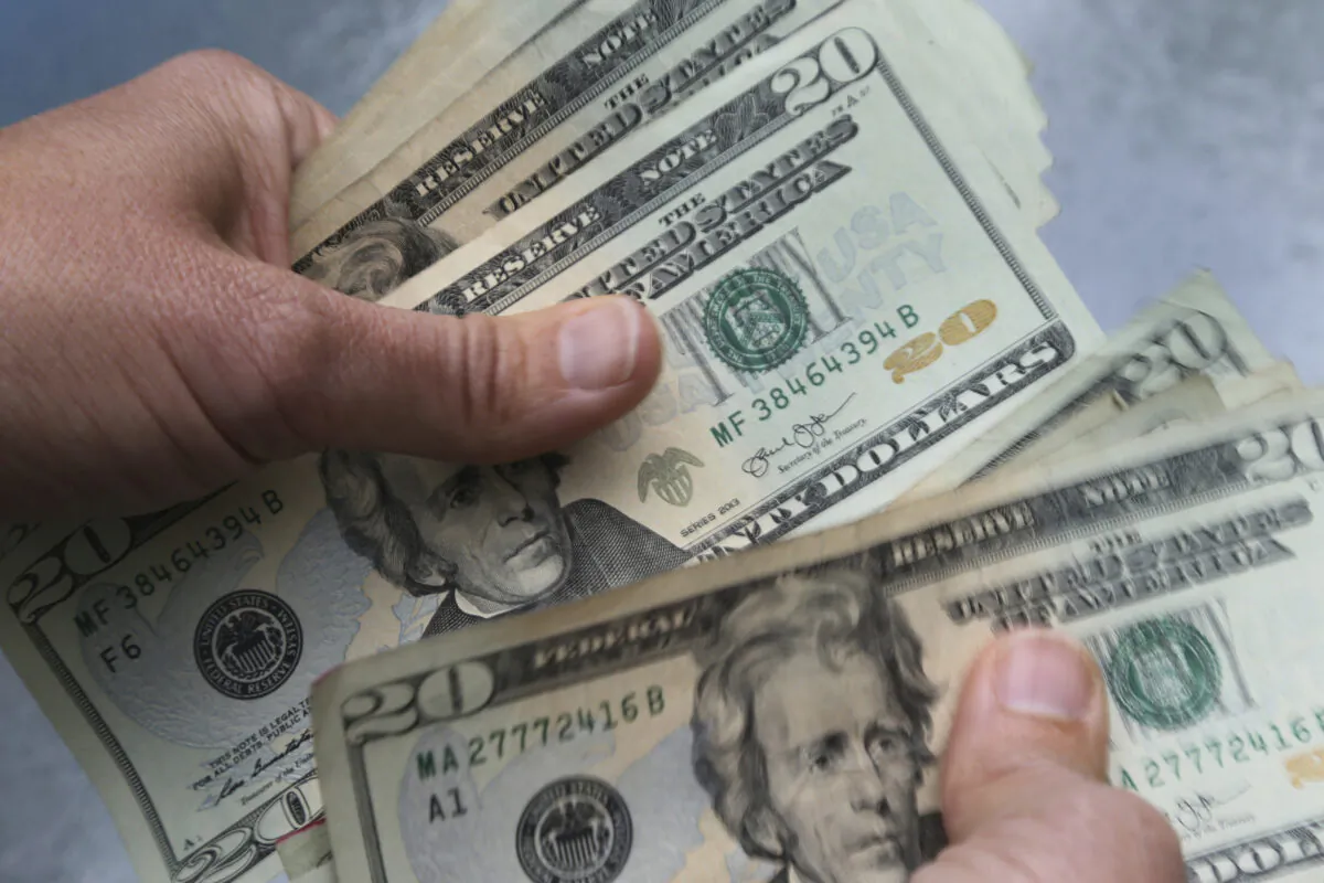 Twenty dollar bills are counted in North Andover, Mass., in a file photo dated June 15, 2018. (Elise Amendola/AP Photo)