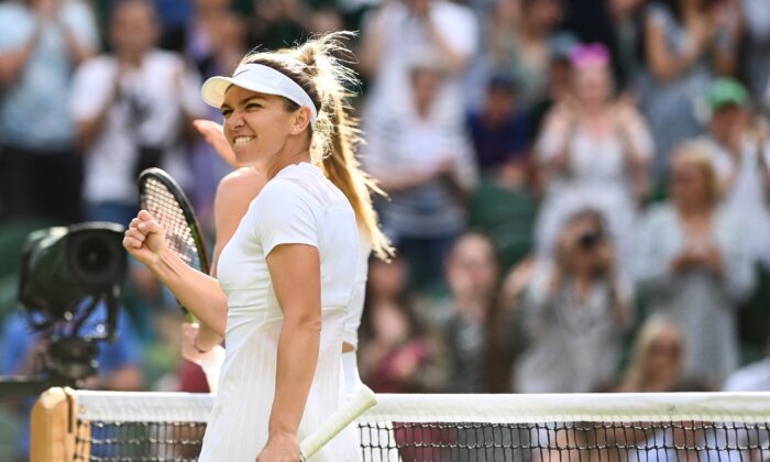Romania's Simona Halep celebrates winning against Spain's Paula Badosa at the end of their round of 16 women's singles tennis match on the eighth day of the 2022 Wimbledon Championships at The All England Tennis Club in Wimbledon, southwest London, on July 4, 2022. (Glyn Kirk/AFP via Getty Images)