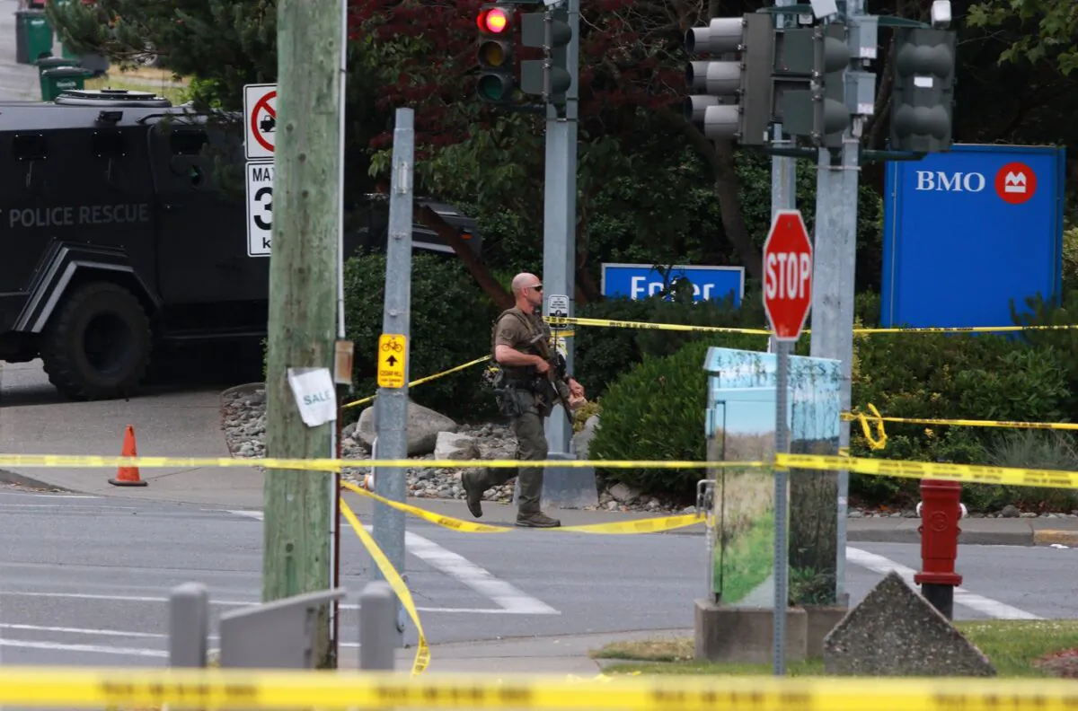 Saanich Police joined by Victoria Police and RCMP respond to shots of gunfire involving multiple people and injuries reported at the Bank of Montreal during an active situation in Saanich, B.C., on June 28, 2022 (The Canadian Press/Chad Hipolito)