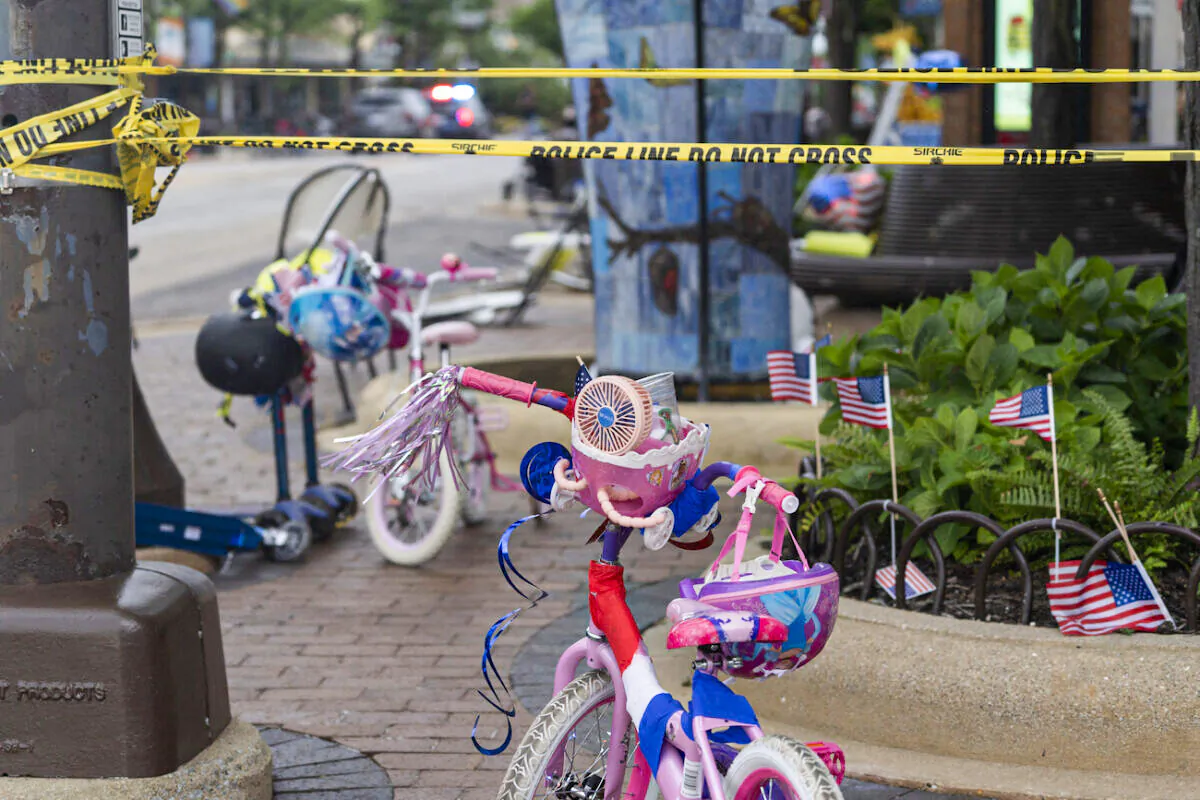 Police crime tape is seen around the area where children's bicycles and baby strollers stand near the scene of the Fourth of July parade shooting in Highland Park, Ill., on July 4, 2022. (Youngrae Kim/AFP via Getty Images)