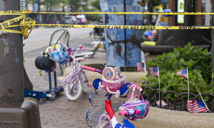 Police crime tape is seen around the area where children's bicycles and baby strollers stand near the scene of the Fourth of July parade shooting in Highland Park, Ill., on July 4, 2022. (Youngrae Kim/AFP via Getty Images)