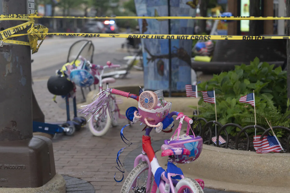 Police crime tape is seen around the area where children's bicycles and baby strollers stand near the scene of the Fourth of July parade shooting in Highland Park, Ill., on July 4, 2022. (Youngrae Kim/AFP via Getty Images)