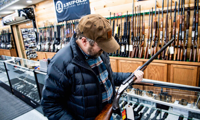 A customer looks at an antique shotgun at a gun shop in Ottawa, Ohio, on Jan. 23, 2020. (Brendan Smialowski/AFP via Getty Images)