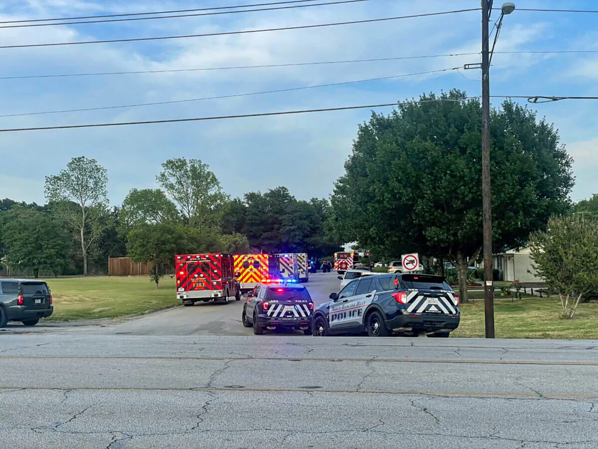 Law enforcement work the scene where multiple shots were fired near the area of Cedarcrest Drive and Diamond Oaks Drive in Haltom City, Texas, Saturday, July 2, 2022.  (James Hartley/Star-Telegram via AP)