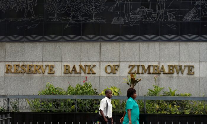 People walk past the Reserve Bank of Zimbabwe in Harare on Feb. 25, 2019. (Philimon Bulawayo/Reuters)