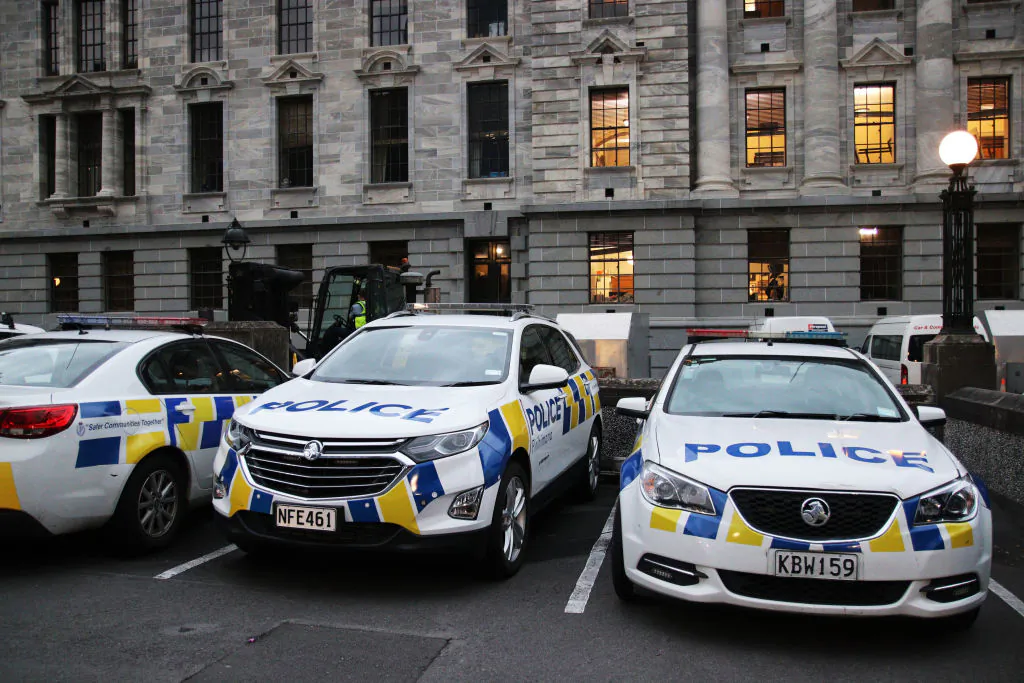 Police cars parked behind Parliament and Victoria University in Wellington, New Zealand, on March 2, 2022. (Lynn Grieveson/Getty Images)
