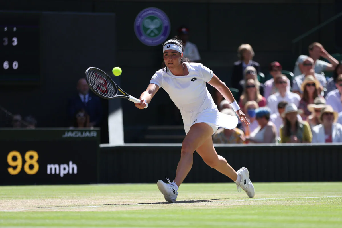 Ons Jabeur of Tunisia plays a forehand against Tatjana Maria of Germany during their Women's Singles Semifinal match on day eleven of The Championships Wimbledon 2022 at All England Lawn Tennis and Croquet Club in London on July 7, 2022. (Clive Brunskill/Getty Images)