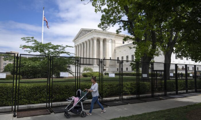 A woman pushes a stroller as she walks by the U.S. Supreme Court in Washington on May 11, 2022. (Drew Angerer/Getty Images)