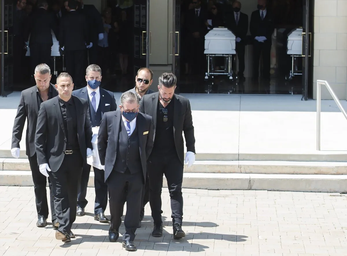 Pallbearers carry the caskets of Karolina Ciasullo and her three young daughters, six year-old Klara Ciasullo, four year-old Lilianna Ciasullo and one year-old Mila Ciasullo, who were killed in a fatal vehicle crash in Brampton, leave the funeral service in Brampton, Ont., on June 25, 2020. (The Canadian Press/Nathan Denette)