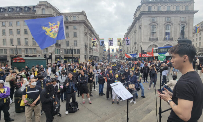 Hongkongers in the UK hold a memorial event, 1st July Commemoration of the 1st Death Anniversary of Leung Kin-fai, at Piccadilly Circus in central London, on July 1, 2022. (Wen Dongqing/The Epoch Times)