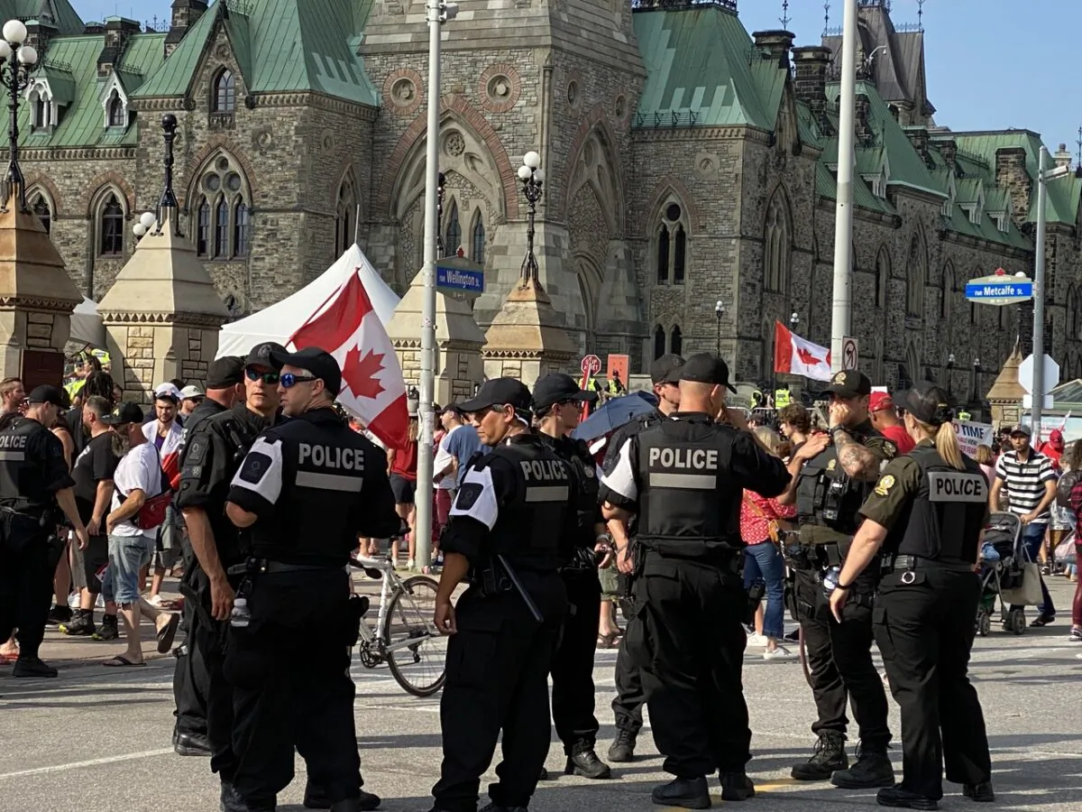 A heavy police presence is seen in Ottawa as people gather in the national capital to mark Canada Day on July 1, 2022. A rally was held on Parliament Hill following a parade through the city's downtown to protest federal COVID-19 mandates. (Limin Zhou/The Epoch Times)