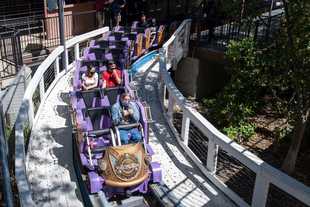Visitors wearing face masks ride the Twisted Colossus roller coaster at the theme park Six Flags Magic Mountain on the day of the park's re-opening, in Valencia, Calif., April 1, 2021. (Valerie Macon/AFP via Getty Images)