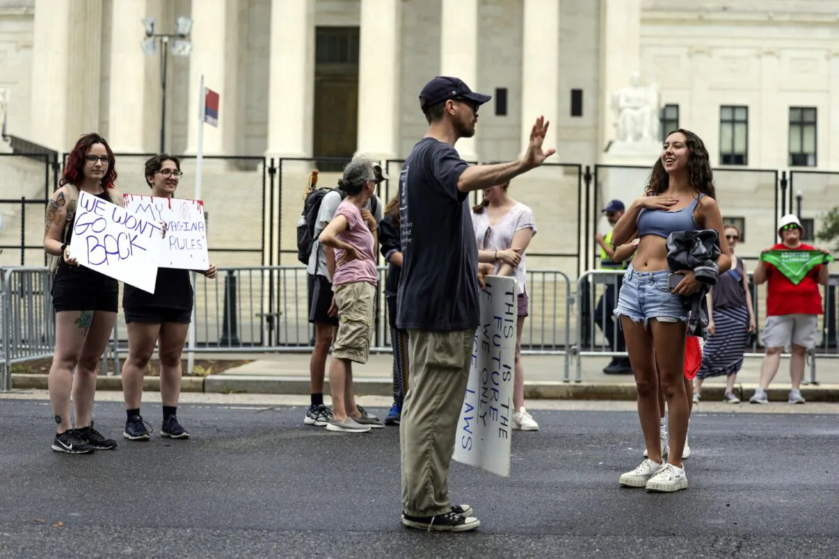 An anti-abortion demonstrator debates with an abortion rights activist as they protest outside the U.S. Supreme Court in Washington on June 27, 2022. (Kevin Dietsch/Getty Images)