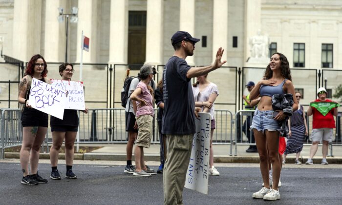 An anti-abortion demonstrator debates with an abortion rights activist as they protest outside the U.S. Supreme Court in Washington on June 27, 2022. (Kevin Dietsch/Getty Images)