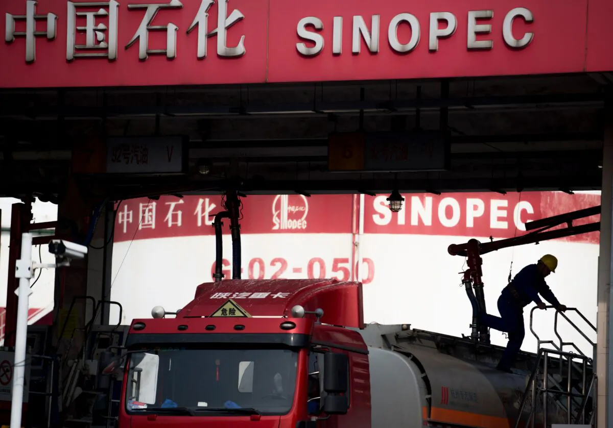 A man works in a filling station of Sinopec in Shanghai on March 22, 2018. (Johannes Eisele/AFP via Getty Images)