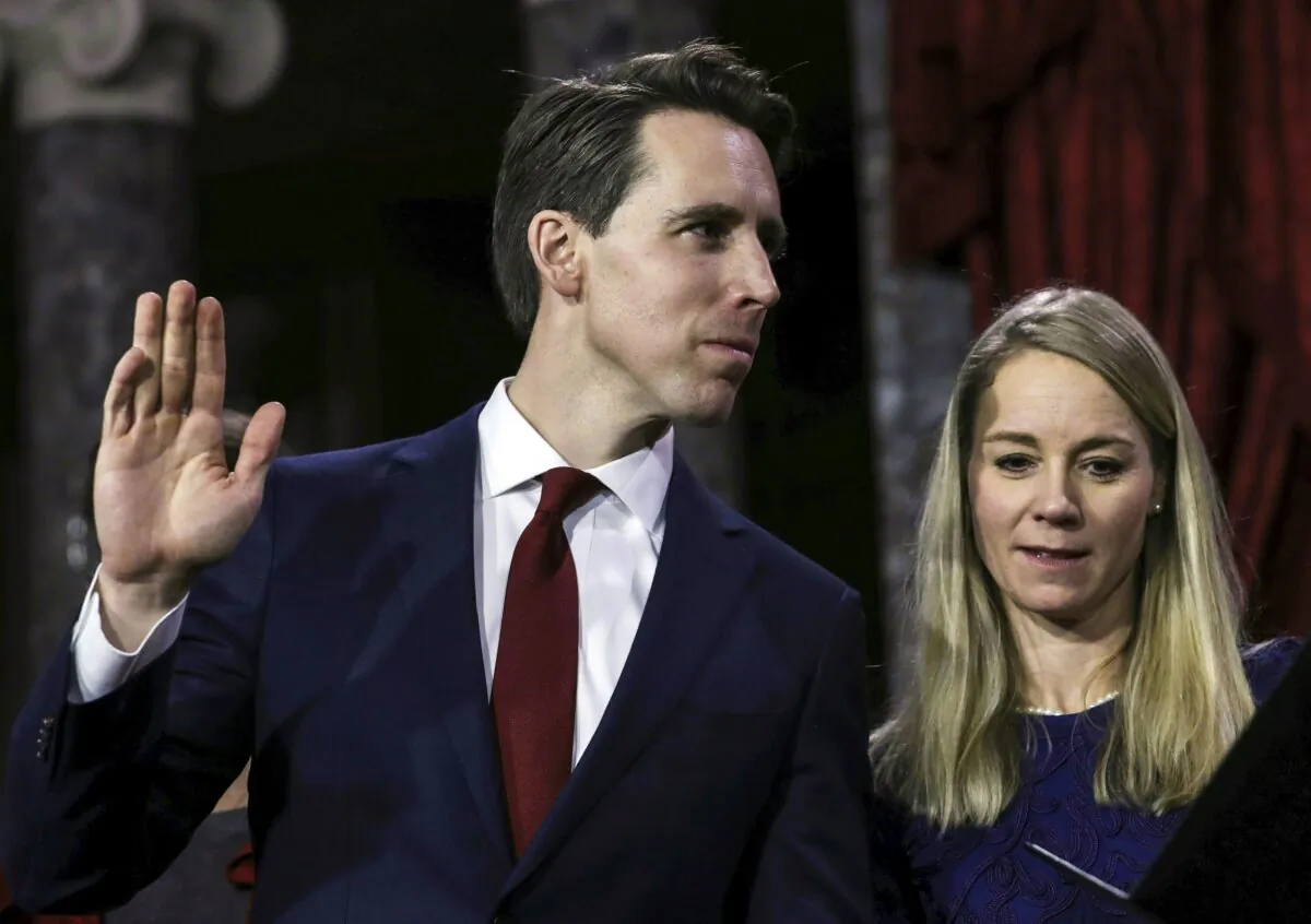 Sen. Josh Hawley (R-Mo.), flanked by his wife Erin and family, is sworn in by Vice President Mike Pence during the swearing-in re-enactments for recently elected senators in the Old Senate Chamber on Capitol Hill in Washington on Jan. 3, 2019. (Alex Edelman/AFP via Getty Images)
