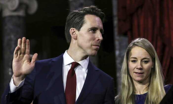 Sen. Josh Hawley (R-Mo.), flanked by his wife Erin and family, is sworn in by Vice President Mike Pence during the swearing-in re-enactments for recently elected senators in the Old Senate Chamber on Capitol Hill in Washington on Jan. 3, 2019. (Alex Edelman/AFP via Getty Images)