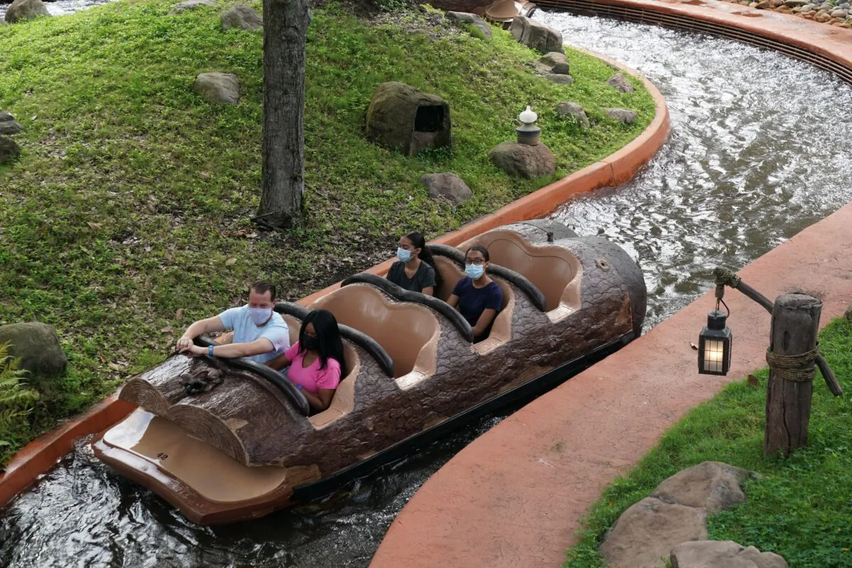 People wearing face masks ride Splash Mountain at Walt Disney World Resort's Magic Kingdom during the COVID-19 pandemic in Orlando on July 23, 2020. (Bryan R. Smith/AFP via Getty Images)
