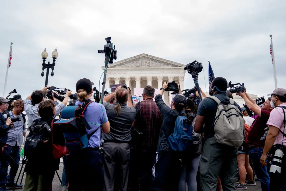 Members of the media gather around demonstrators outside the U.S. Supreme Court on June 21, 2022. (Stefani Reynolds/AFP via Getty Images)