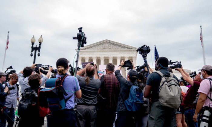 Members of the media gather around demonstrators outside the U.S. Supreme Court on June 21, 2022. (Stefani Reynolds/AFP via Getty Images)