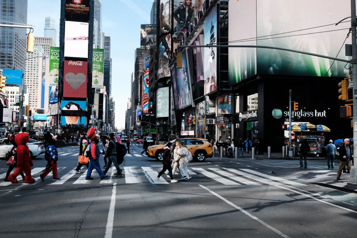 People walk through Times Square on March 11, 2022, in New York City. (Spencer Platt/Getty Images)