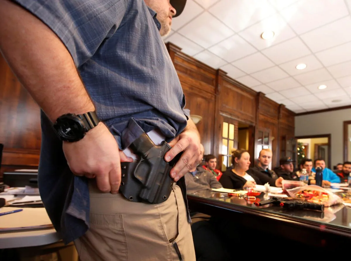 Damon Thueson shows a holster at a gun concealed carry permit class put on by "USA Firearms Training" on December 19, 2015 in Provo, Utah. (George Frey/Getty Images)