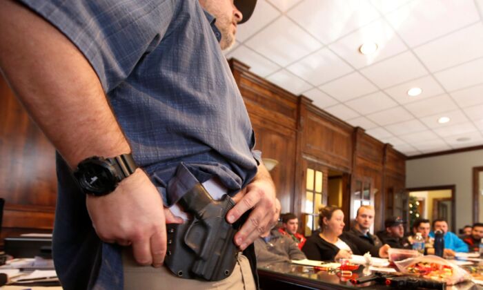Damon Thueson shows a holster at a gun concealed carry permit class put on by "USA Firearms Training" on December 19, 2015 in Provo, Utah. (George Frey/Getty Images)