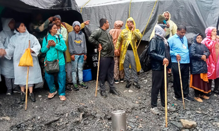 Hindu devotees are stranded after a cloudburst near the base camp of the cave shrine of Amarnath in south of Kashmir Himalayas, in India, on July 8, 2022. (Jammu and Kashmir Government's Department of Disaster Management via AP)
