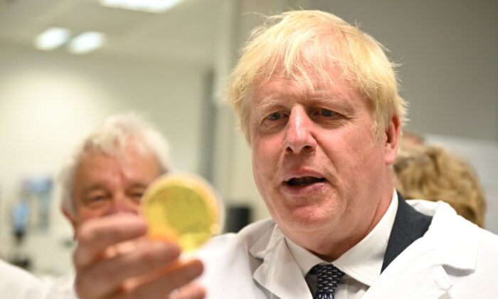 Prime Minister Boris Johnson looks at samples in a laboratory during a visit to the national flagship for biomedical research, the Francis Crick Institute, in central London, on July 11, 2022. (Leon Neal/PA Media)