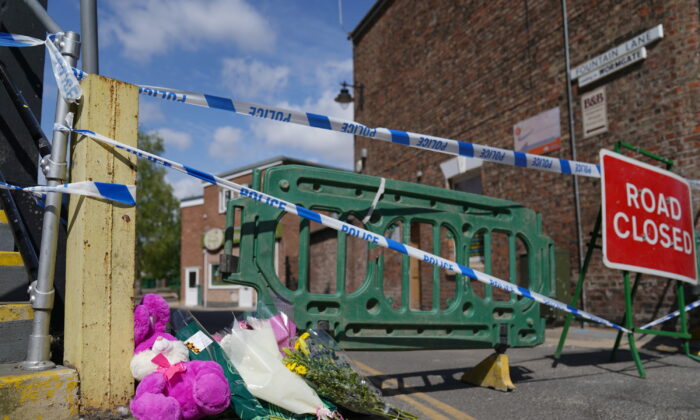 Floral tributes left near to the scene where a nine-year-old girl died from a suspected stab wound, in Boston, Lincolnshire, England, on July 29, 2022. (Joe Giddens/PA Media)